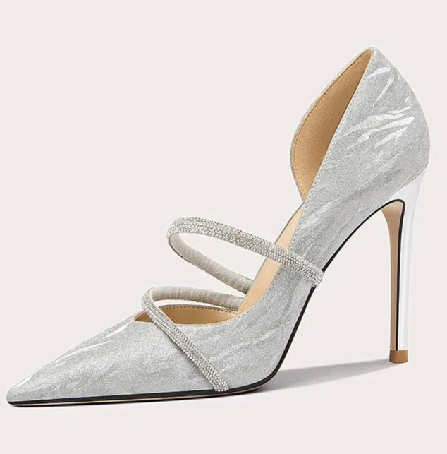 Silver high-heeled shoe with a strap on a white background
