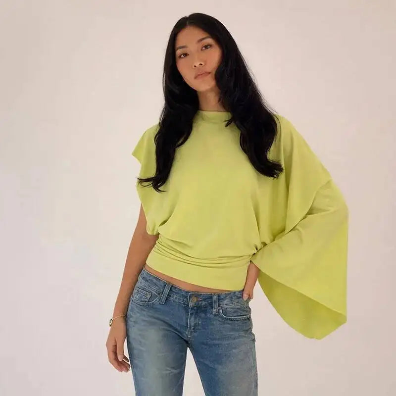 Close-up of the asymmetrical drop-shoulder knit top