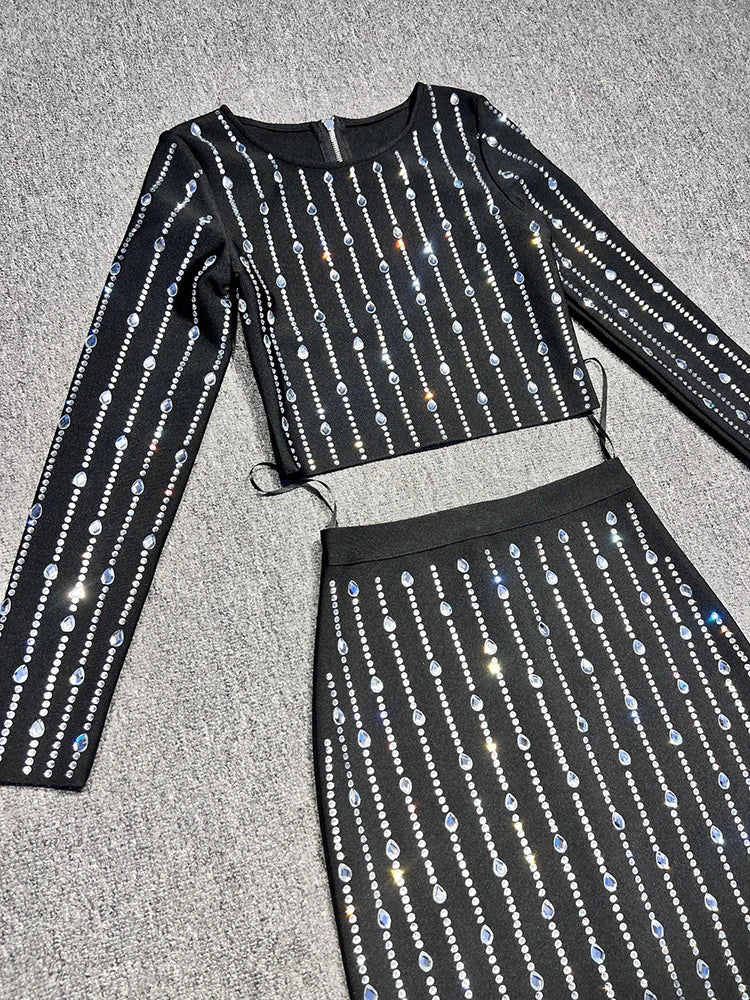 Black outfit with silver sequin details on a gray surface