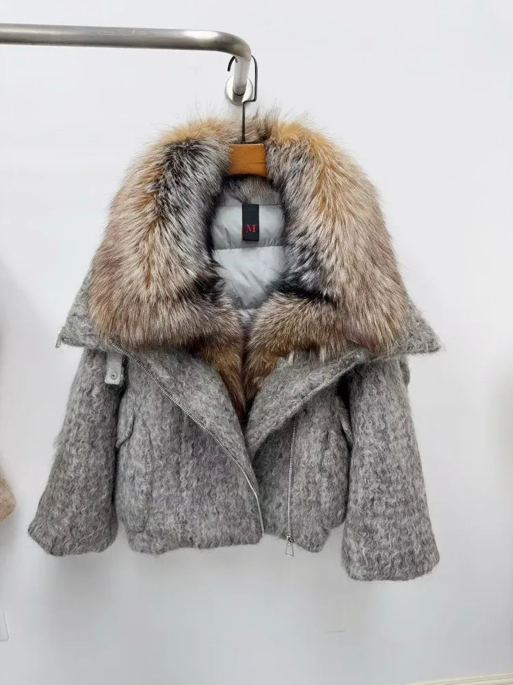 Gray coat with fur hood on a hanger against a white background