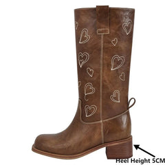 Side view of brown embroidered heart knee-high boots showing heel height