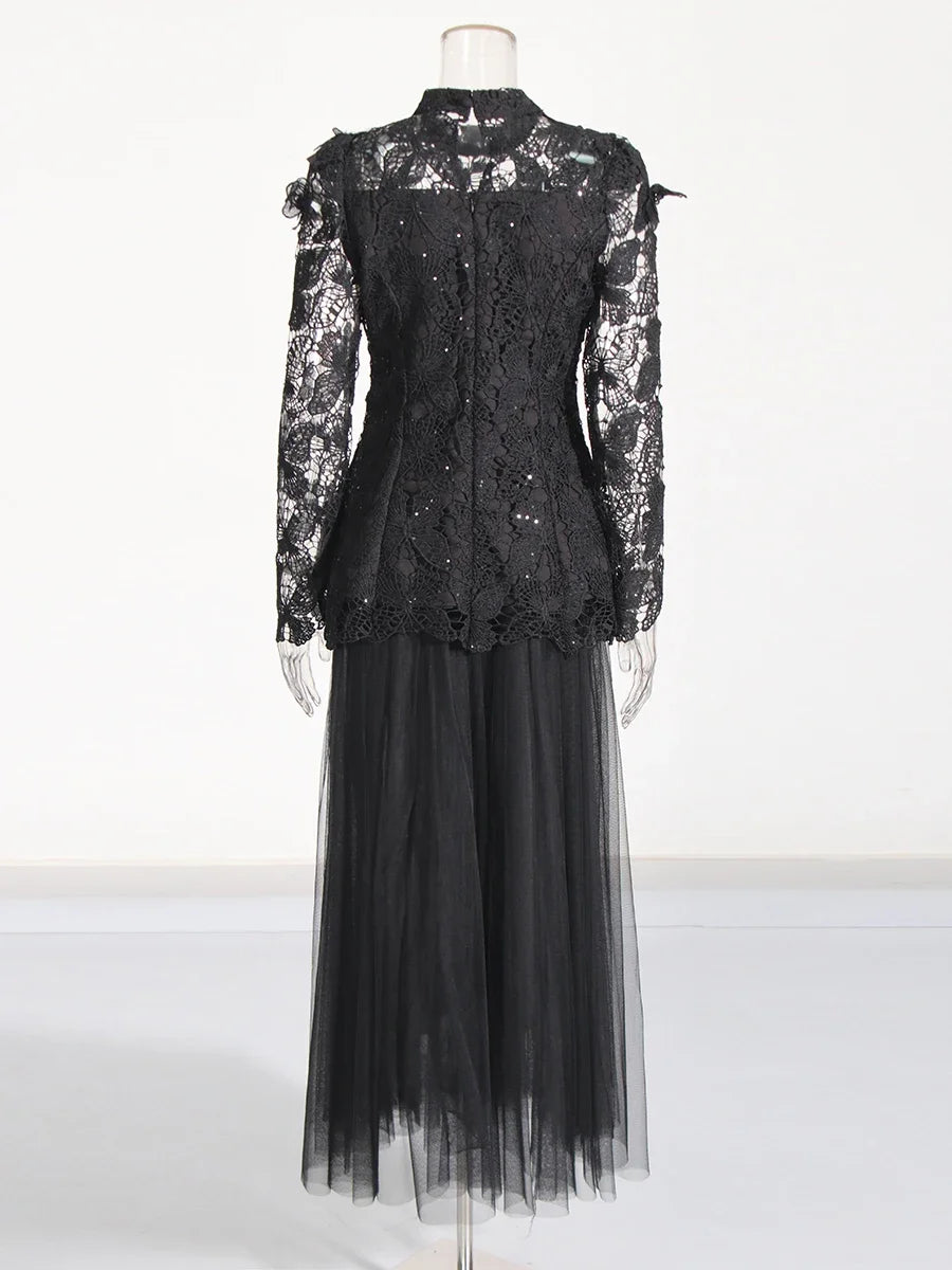 Black lace dress on a mannequin against a white background