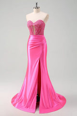 Pink evening gown on a mannequin against a light gray background