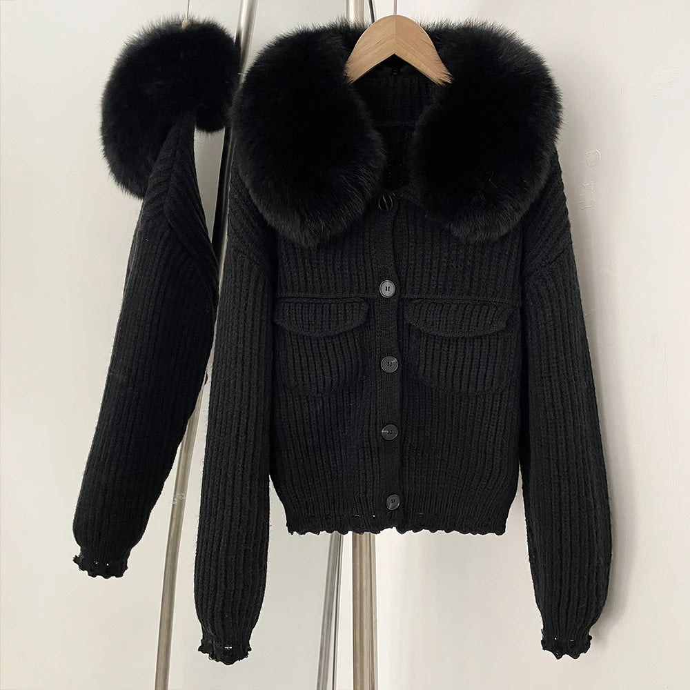 Black ribbed knit jacket with a large natural black fur collar.