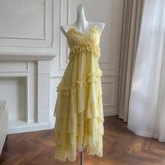 Yellow ruffled chiffon maxi dress on a mannequin, front view.
