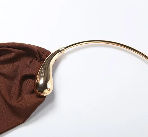 Gold necklace on a brown fabric background