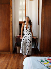 White polka dot maxi dress with a plunging neckline and open back.