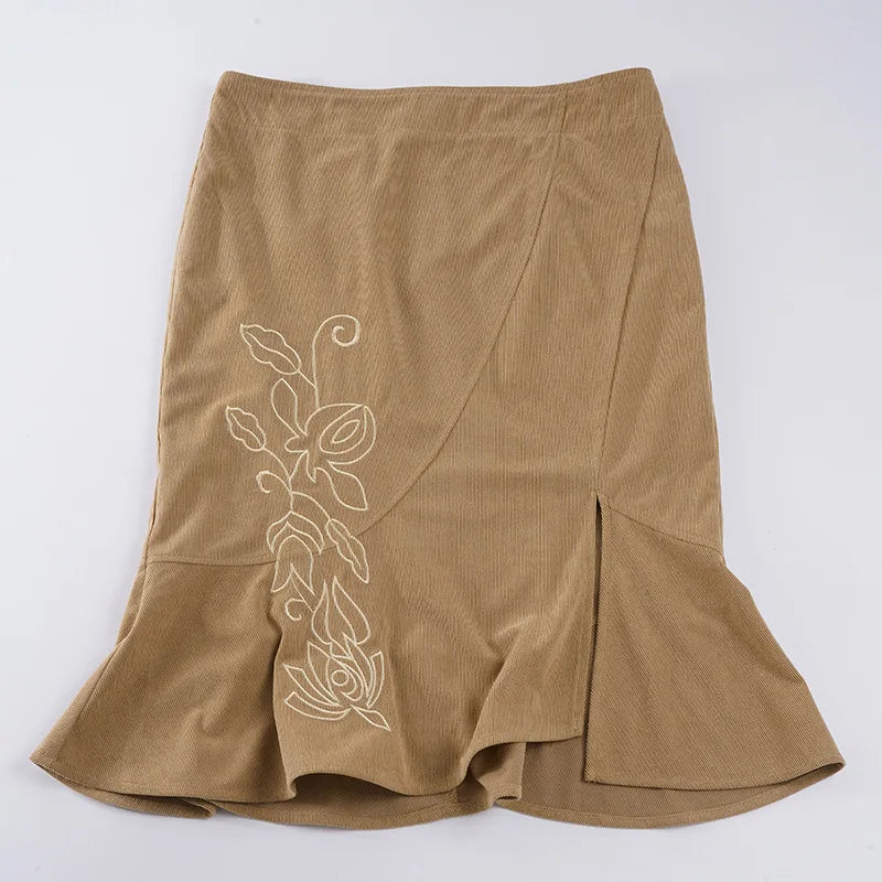 Brown skirt with floral embroidery on a white background