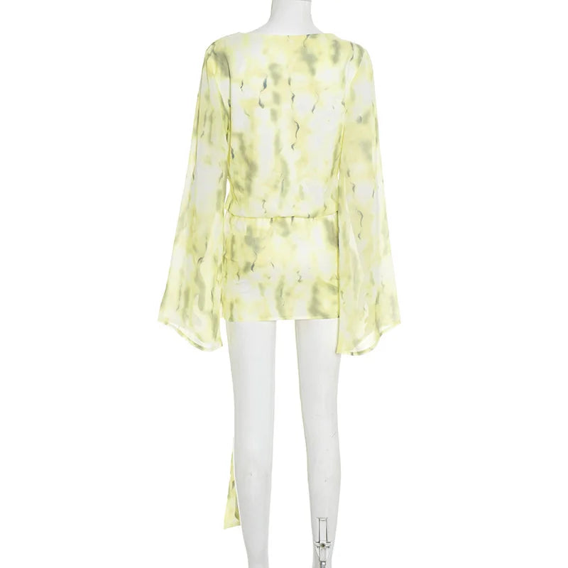Yellow floral blouse on a mannequin against a white background