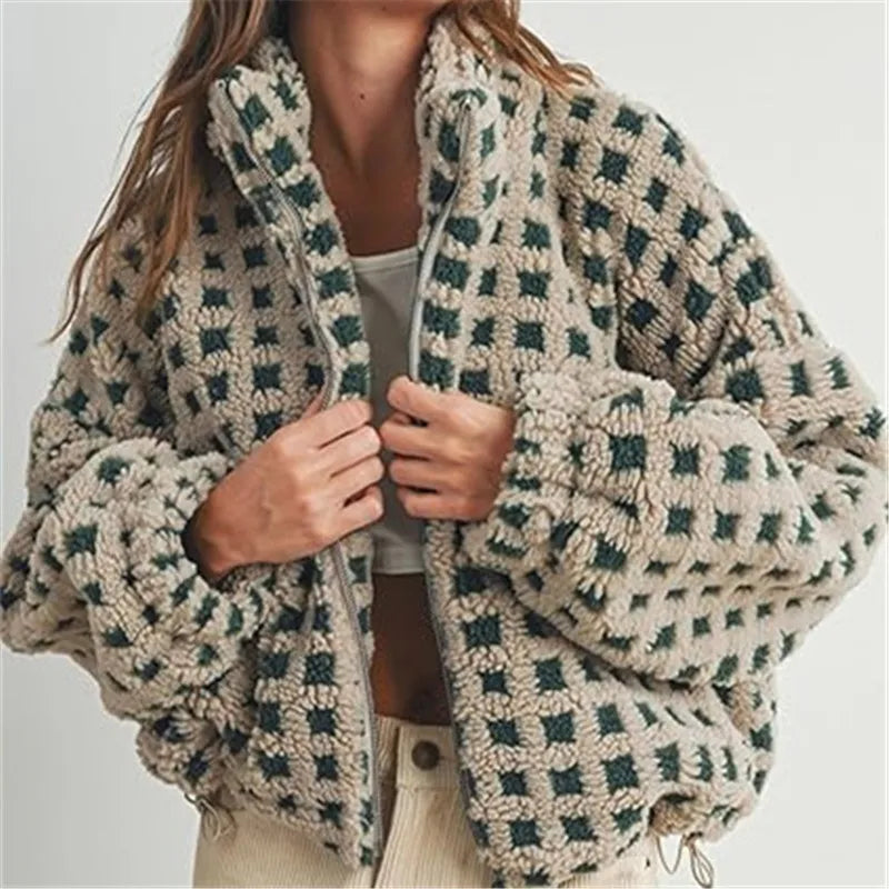 Person wearing a patterned cardigan with a neutral background