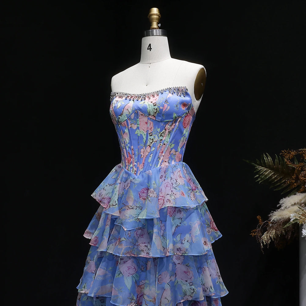 Floral tiered dress on a mannequin against a black background