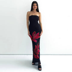  A woman wearing a black floral tube maxi dress with a tie-back detail, showcasing its elegant design. Golden Atelier 4