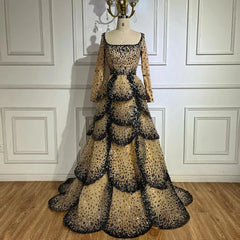 Black beaded tiered tulle evening gown with full sleeves and square neckline.
