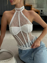 Woman wearing a sheer lace top and jeans in an indoor setting