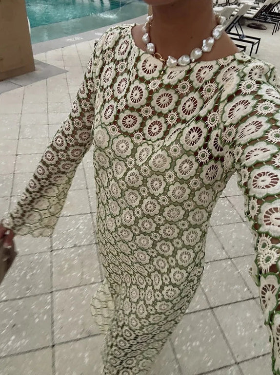 Person wearing a floral dress with a pool in the background