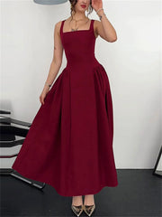 Burgundy dress worn by a model on a plain background