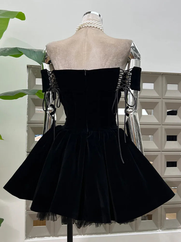 Black dress on a mannequin with a white background