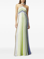 Woman wearing a long, multicolored striped dress on a white background