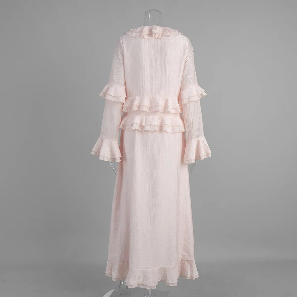 Pink dress with ruffled details on a grey background