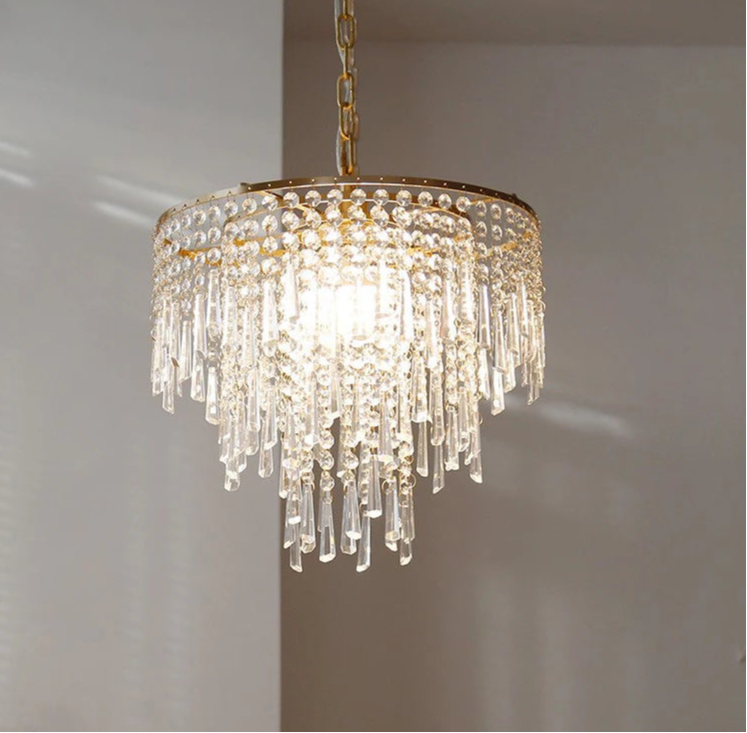 Crystal chandelier with gold accents on a neutral background
