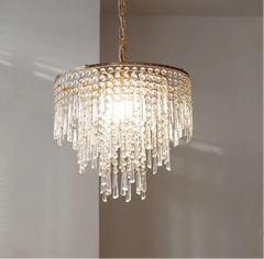 Crystal chandelier with gold accents on a neutral background