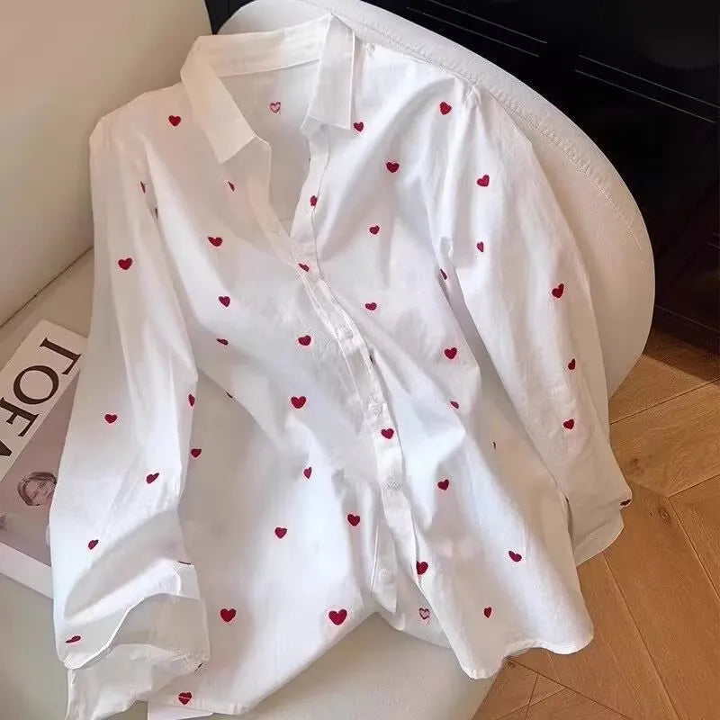 White shirt with red heart patterns on a chair
