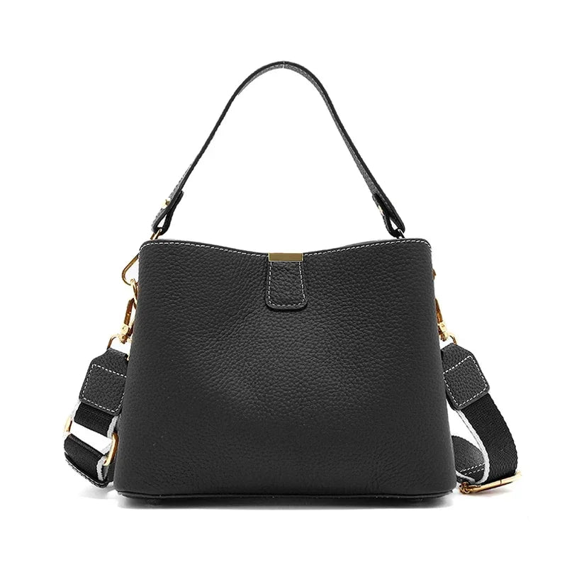 Black handbag with a strap on a white background