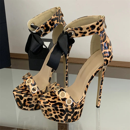 Leopard print platform stiletto lace-up sandals with metal eyelets and ribbon ties.