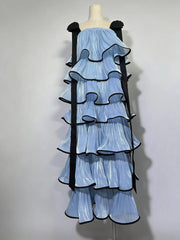 Mannequin wearing a light blue dress with black ruffled straps on a white background