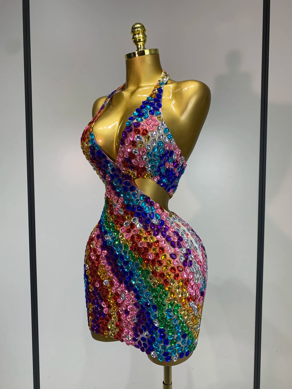 Side view of a halter neck mini dress with rainbow diamond embellishments