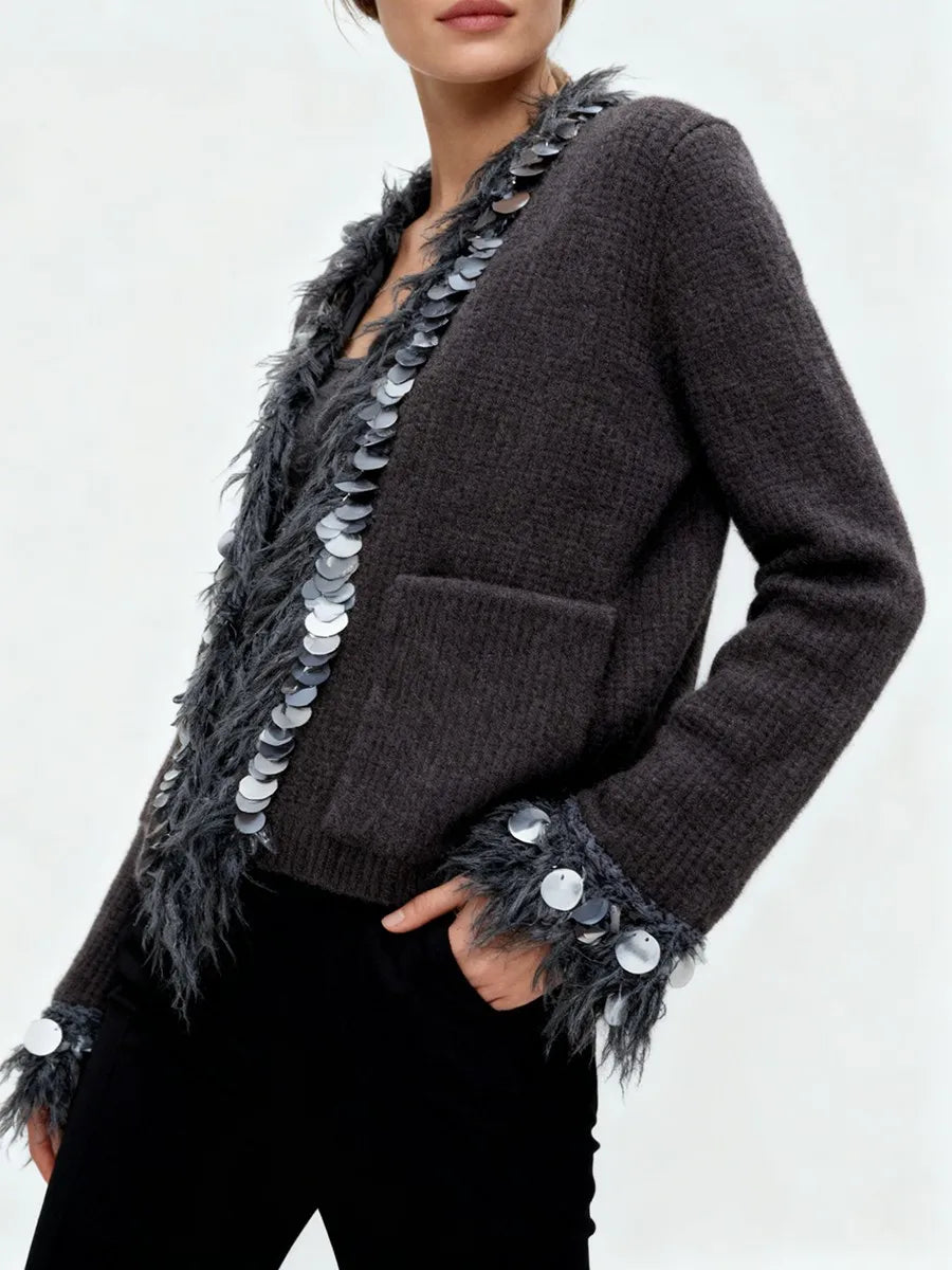 Dark gray cardigan with feather and sequin details on a plain background
