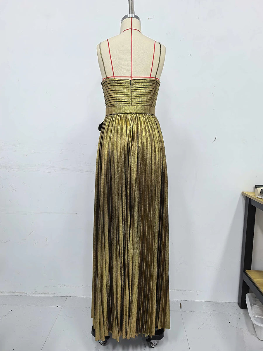Gold evening gown on a mannequin against a white background