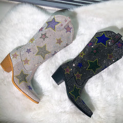 Pair of cowboy boots with star patterns on a white fur background
