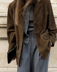 A stylish woman wearing a vintage suede coat, showcasing its elegant design and luxurious texture . Golden Atelier 4