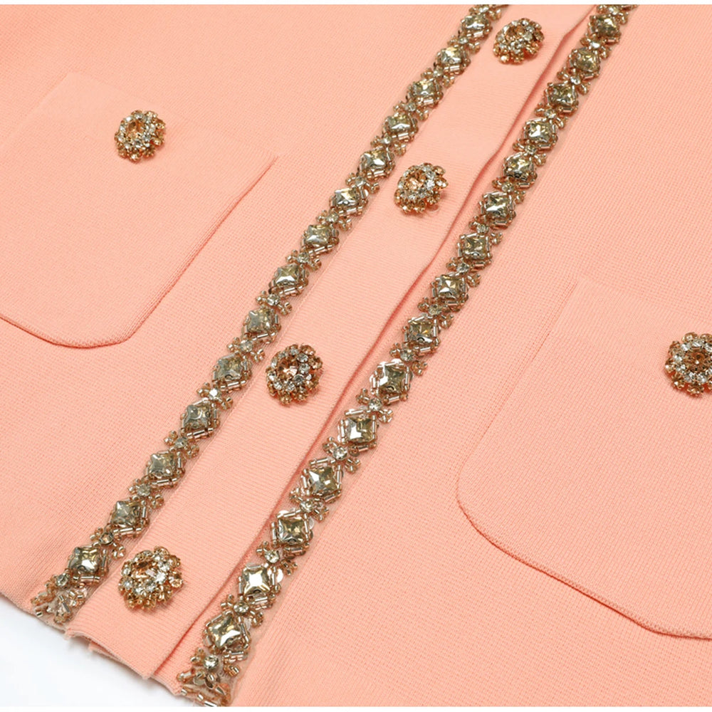Close-up of pink knit top pockets and button placket embellishments