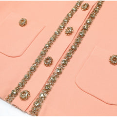 Close-up of pink knit top pockets and button placket embellishments
