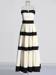 Black and white striped dress on a mannequin against a plain background