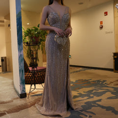 A model wearing the blue mermaid evening gown, showcasing its flattering silhouette and flowing train.  Golden Atelier 4