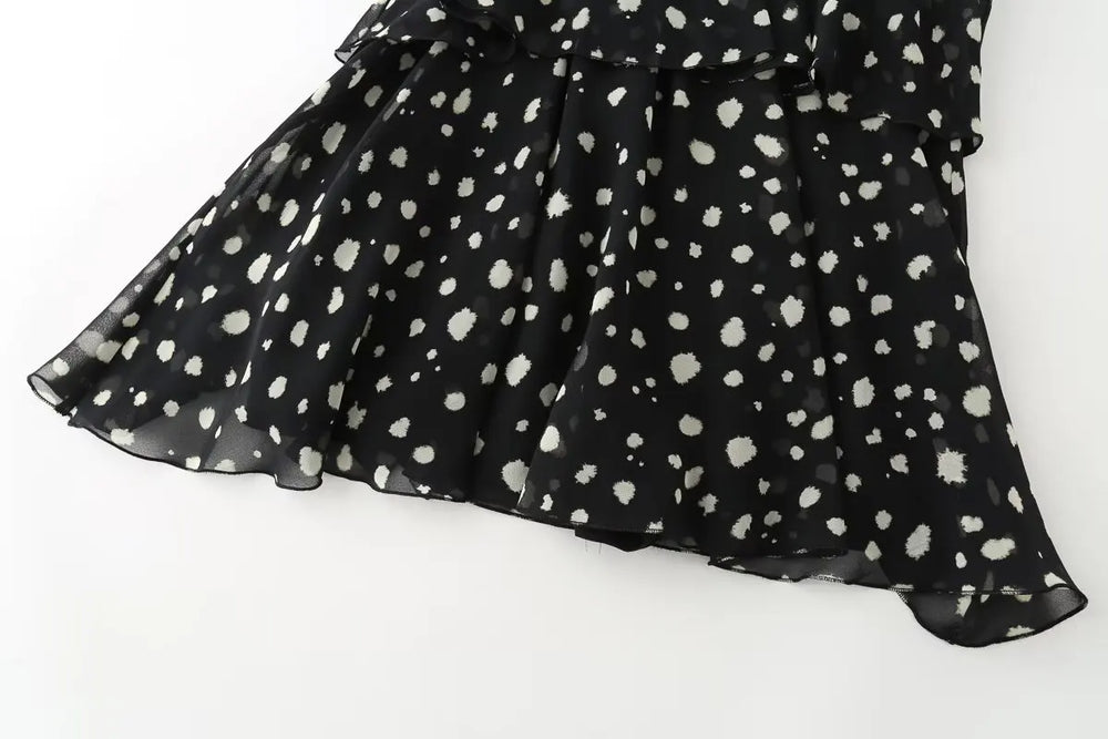 Detail of the polka dot pattern on the hem of the mini dress
