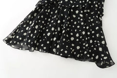 Detail of the polka dot pattern on the hem of the mini dress