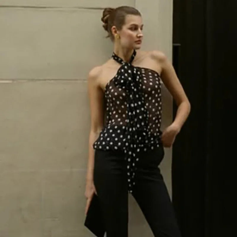 Model posing in a polka dot halter neck chiffon blouse