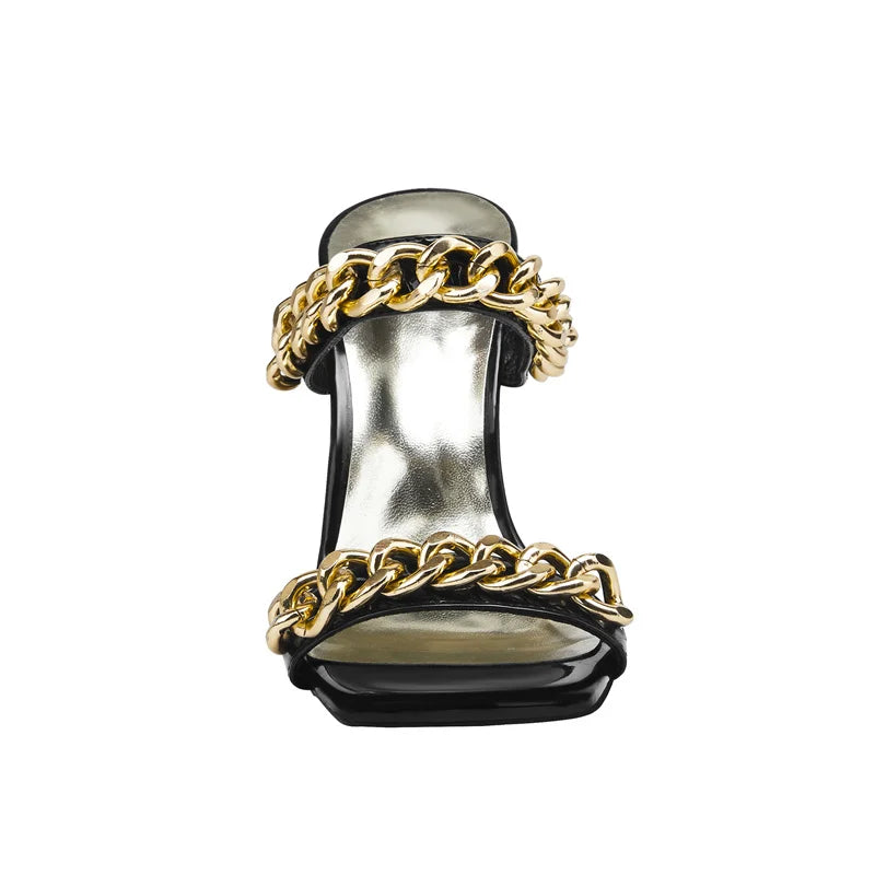 High-heeled shoe with gold chain design on a white background