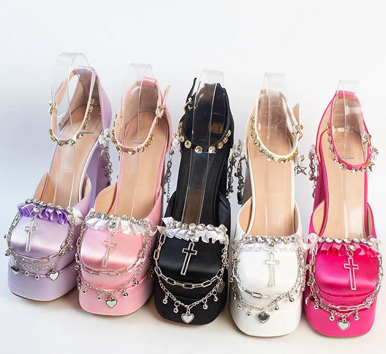 Set of five high-heeled shoes in different colors with decorative charms on a white background