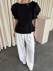 Full body view of black puff sleeve peplum blouse