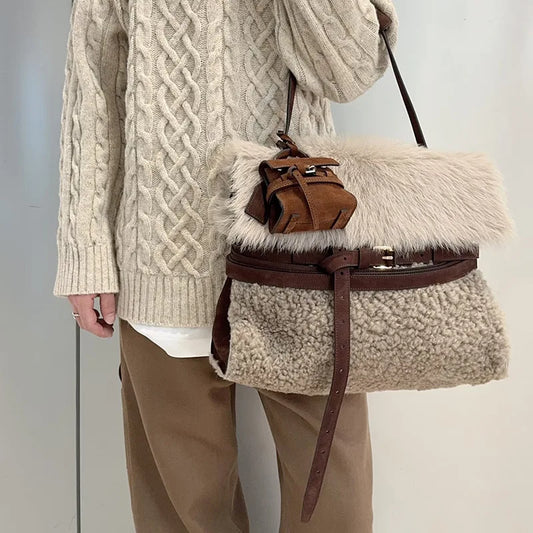 Plush fur belted messenger bag with a thick strap.