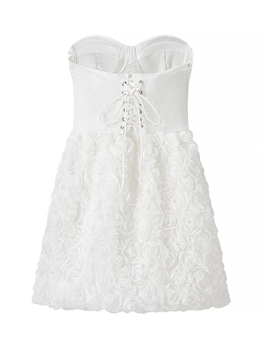 White strapless dress with floral lace details on a white background