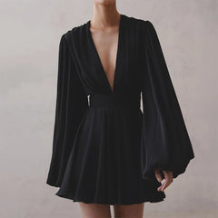 Black dress with long sleeves on a plain background