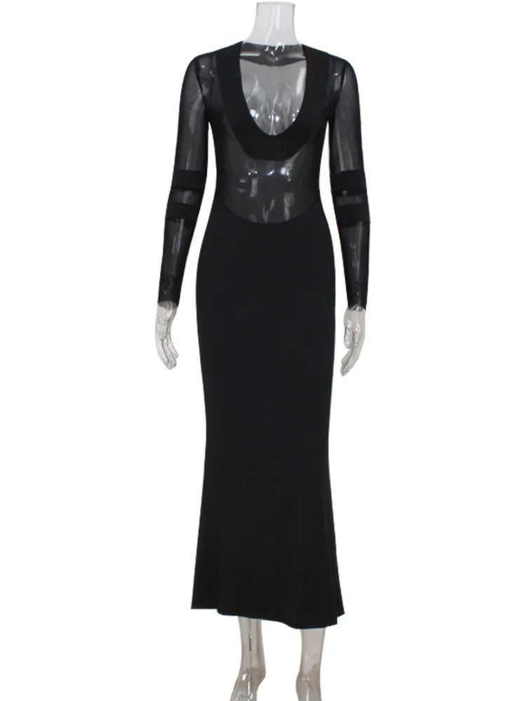 Black dress with sheer sleeves on a mannequin against a white background
