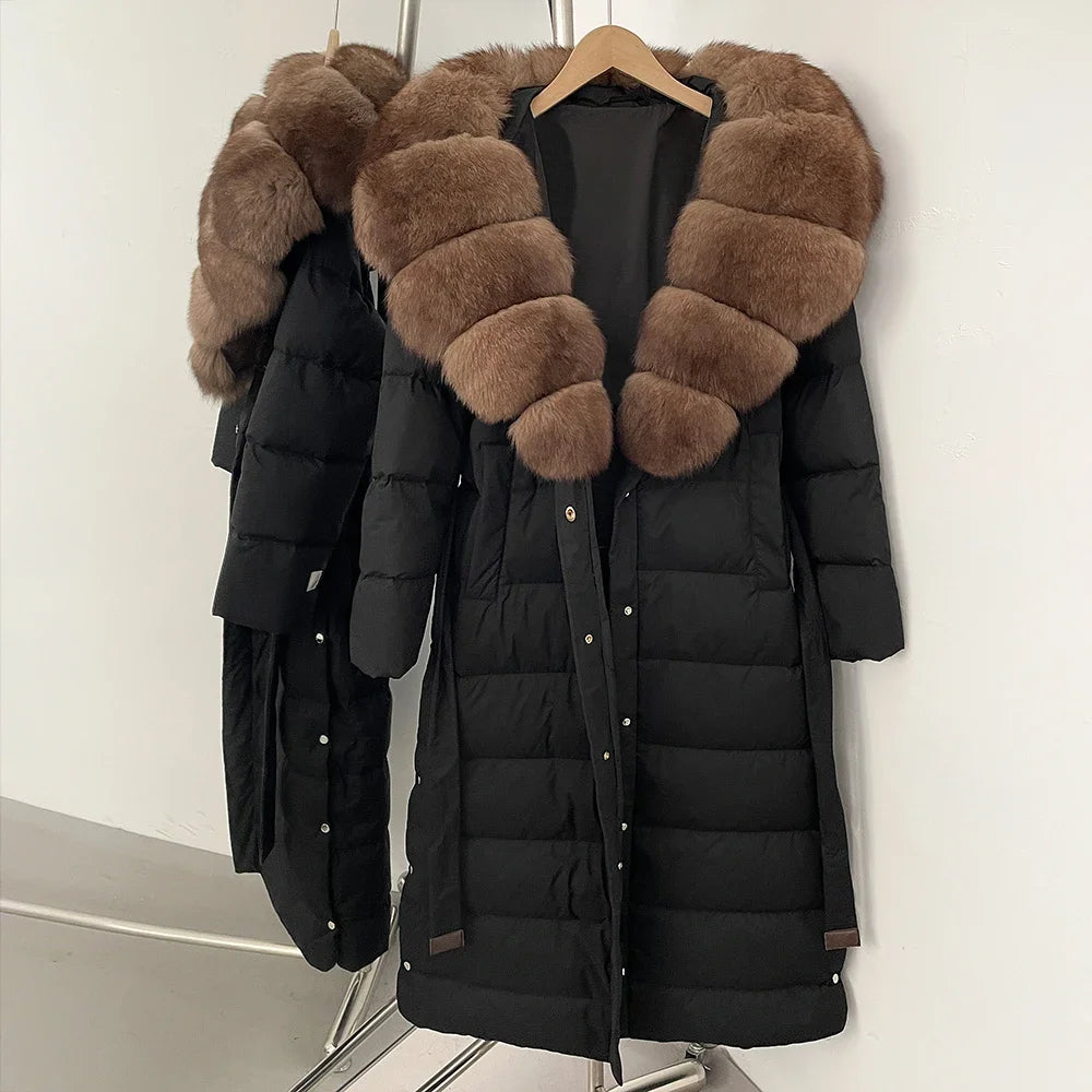 Black puffer coat with brown fur hood on a hanger against a white background