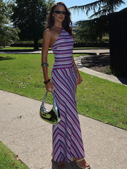 Woman wearing striped halter neck floor-length maxi dress with lace-up detail – perfect for summer parties or elegant night events